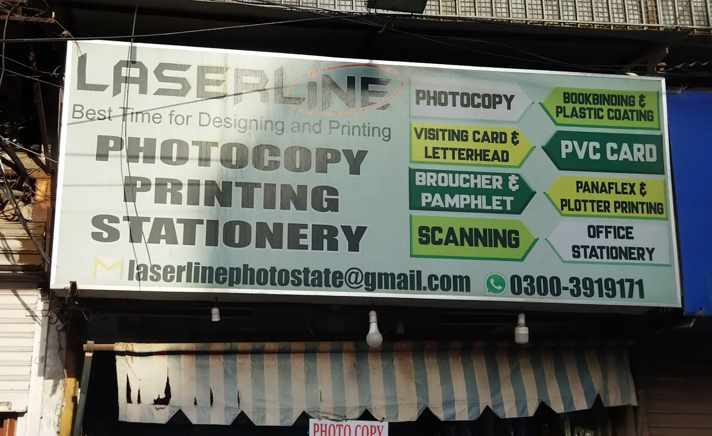 The Laserline sign lit up in the evening